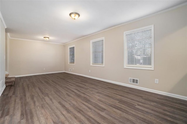 spare room with dark hardwood / wood-style floors and ornamental molding