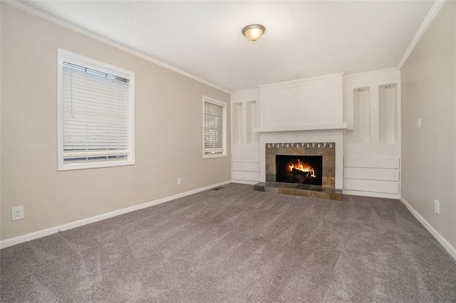 unfurnished living room featuring crown molding, carpet floors, and a fireplace