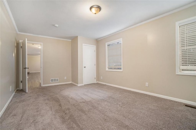 unfurnished bedroom featuring light colored carpet, ornamental molding, and a closet