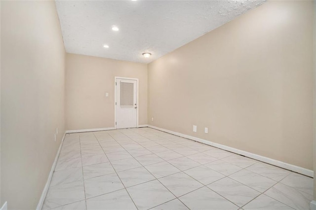 spare room with a textured ceiling