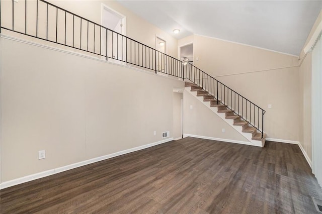 interior space with dark hardwood / wood-style flooring and vaulted ceiling