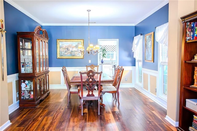 dining area with a chandelier, wood finished floors, and crown molding