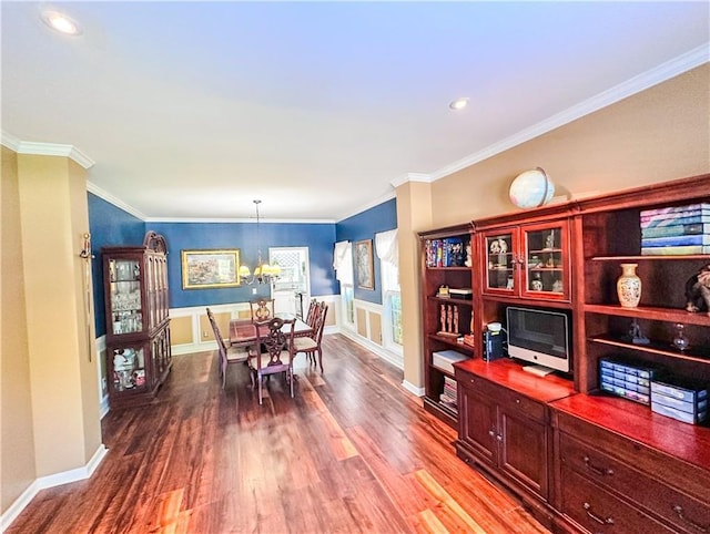 dining space featuring a chandelier, wood finished floors, crown molding, recessed lighting, and baseboards