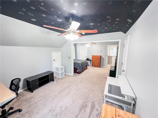 carpeted bedroom featuring vaulted ceiling, baseboards, and a ceiling fan