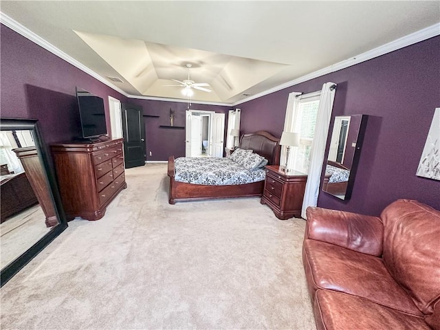 bedroom featuring a tray ceiling, light colored carpet, ornamental molding, lofted ceiling, and ceiling fan