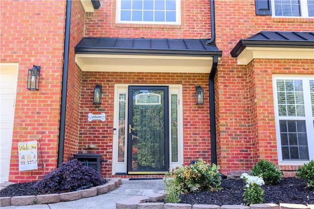 entrance to property with a standing seam roof, brick siding, and metal roof