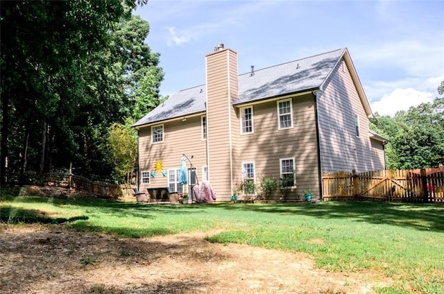 rear view of property featuring a chimney