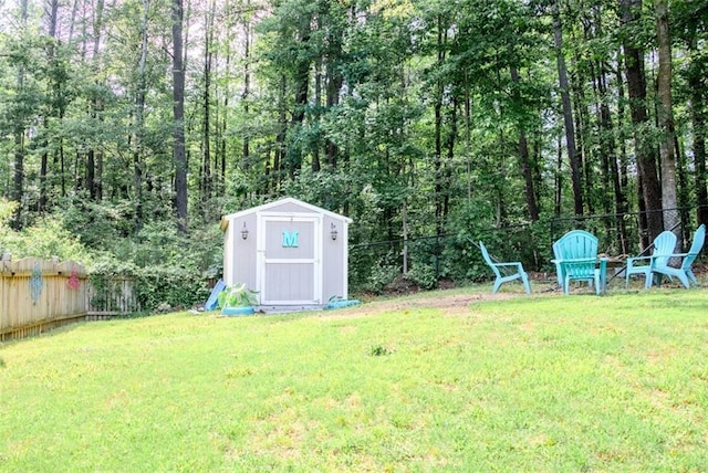 view of yard with a storage shed and an outbuilding