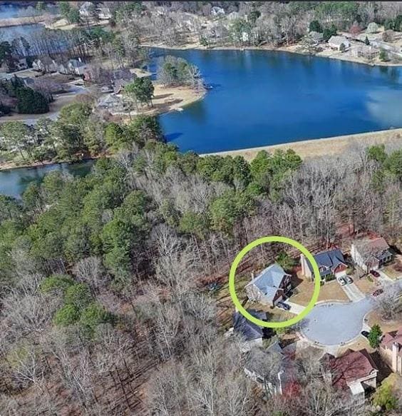 aerial view of property and surrounding area featuring a large body of water