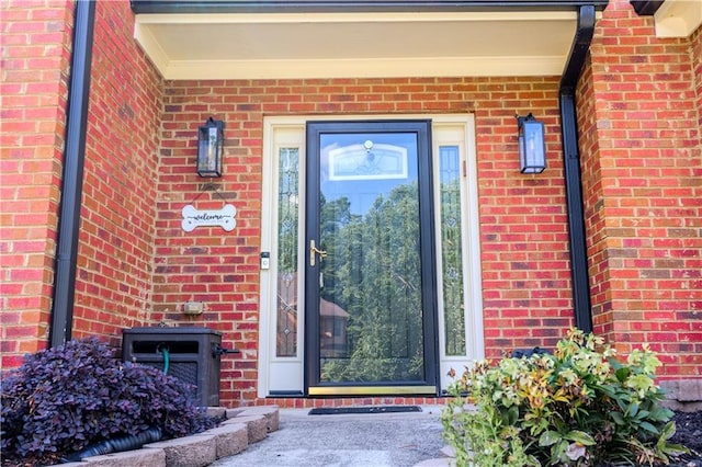 property entrance featuring brick siding