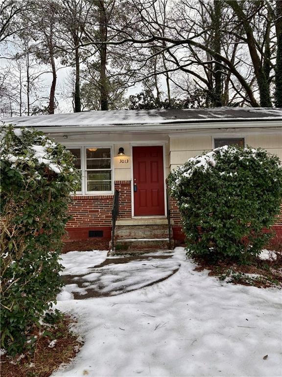 view of snow covered property entrance