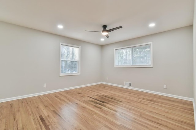 spare room with ceiling fan, light hardwood / wood-style flooring, and plenty of natural light