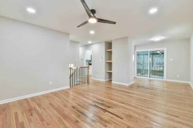 unfurnished living room with ceiling fan and light hardwood / wood-style floors