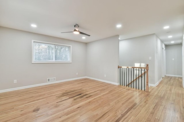 unfurnished room featuring ceiling fan and light hardwood / wood-style flooring