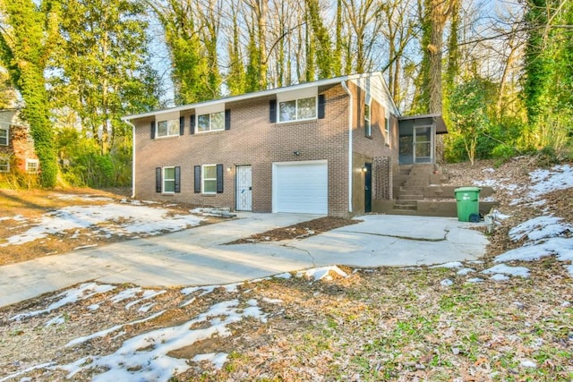 view of front of home featuring a sunroom and a garage