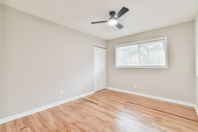 empty room featuring ceiling fan and light hardwood / wood-style floors