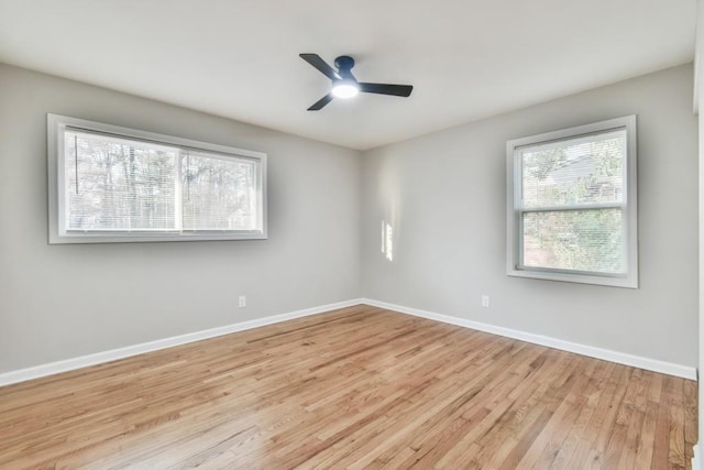 spare room with light wood-type flooring and ceiling fan