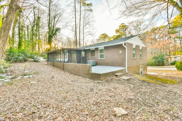 back of property featuring a patio, cooling unit, and a sunroom