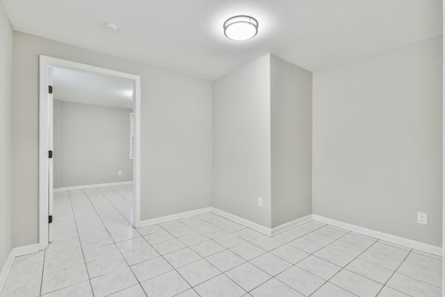 unfurnished room with light tile patterned flooring