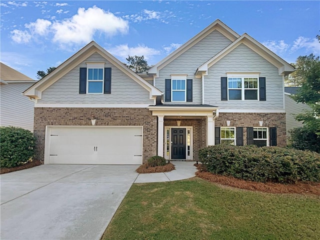 craftsman inspired home with a front lawn, concrete driveway, brick siding, and an attached garage