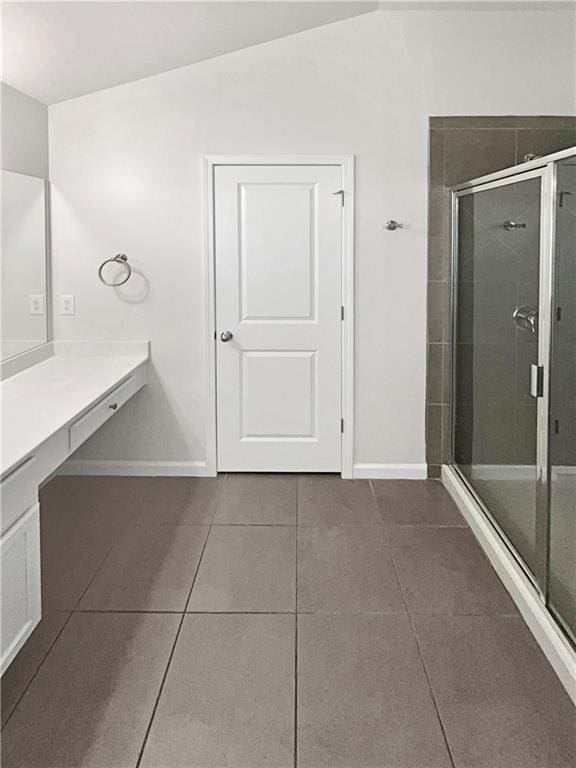 full bathroom featuring a stall shower, vanity, and tile patterned floors