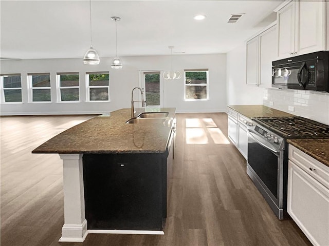 kitchen featuring white cabinets, dark hardwood / wood-style flooring, sink, and stainless steel range with gas cooktop