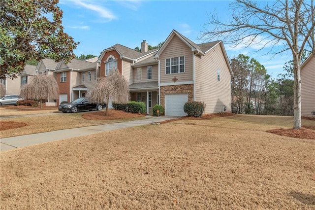 view of front of house with a garage and a front lawn