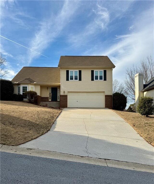 view of front of house with a garage and a front lawn