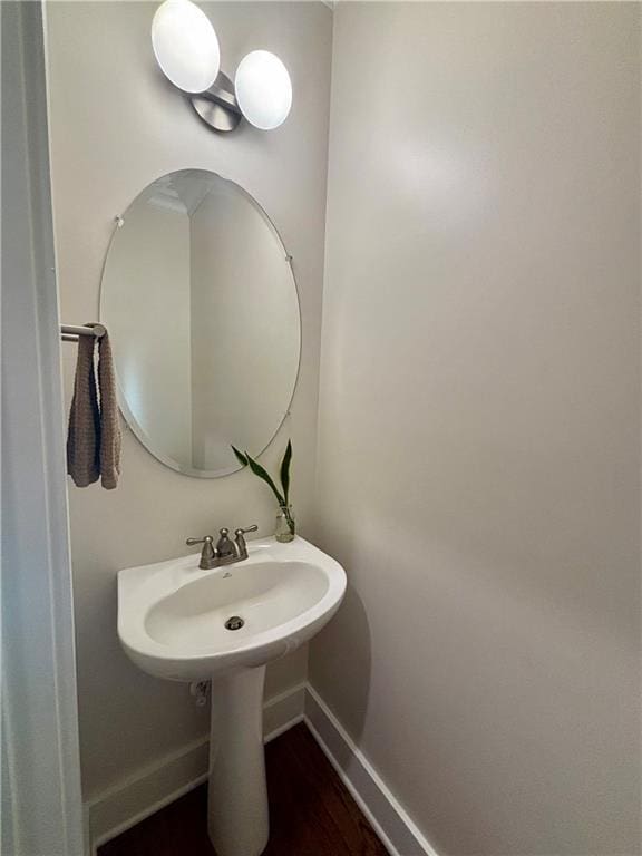 bathroom with baseboards and wood finished floors