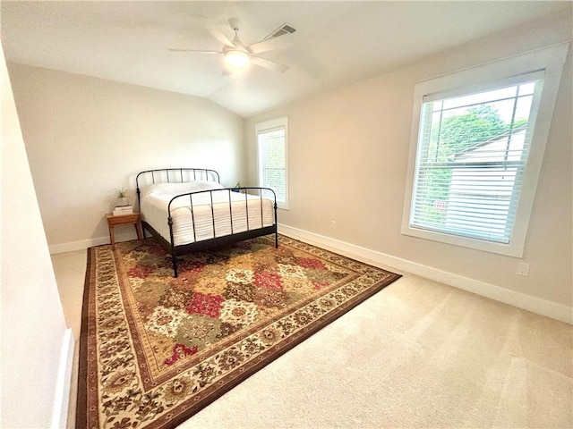 carpeted bedroom featuring multiple windows, lofted ceiling, and baseboards