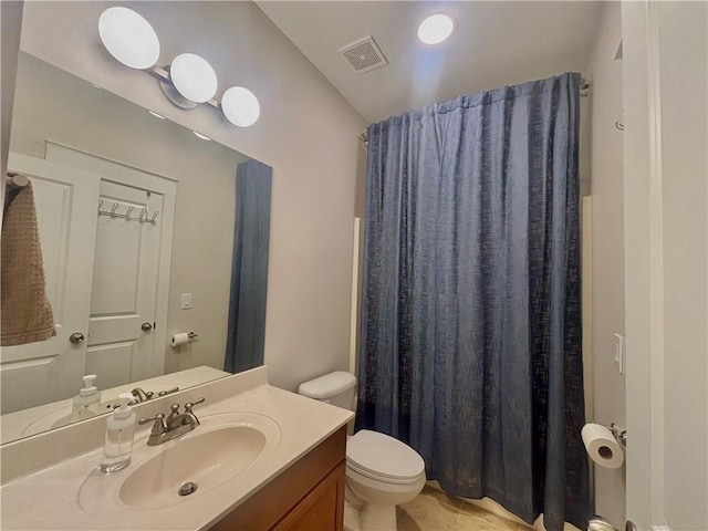 bathroom featuring toilet, vanity, and a shower with shower curtain