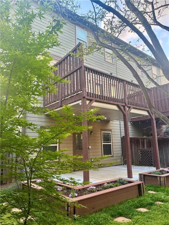 back of property with a balcony and a patio area