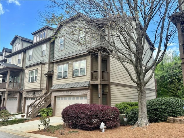 multi unit property featuring a garage and driveway