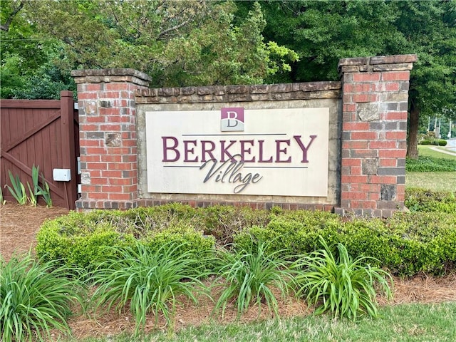 community sign featuring fence