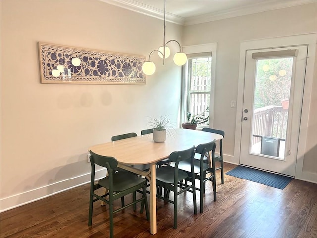 dining room featuring crown molding, baseboards, and dark wood finished floors