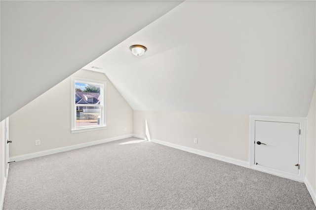 bonus room featuring lofted ceiling and carpet floors