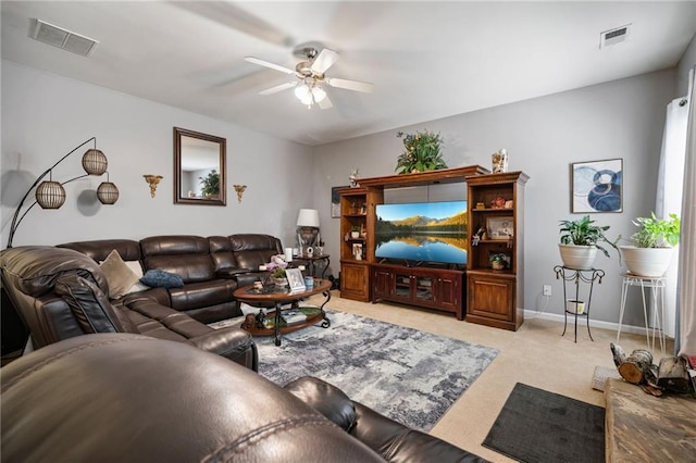 living room with light colored carpet, visible vents, a ceiling fan, and baseboards