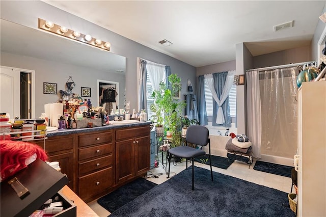 bathroom featuring tile patterned floors, visible vents, a shower with curtain, and vanity