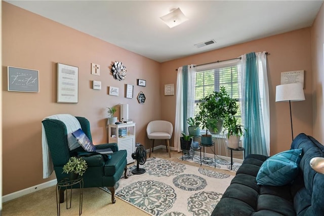 sitting room with baseboards, visible vents, and carpet