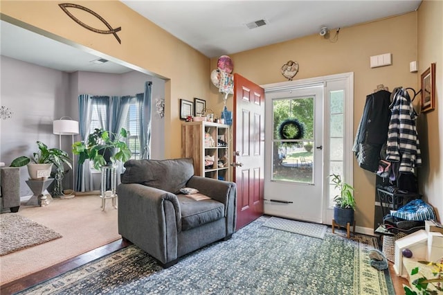 interior space featuring visible vents and carpet floors
