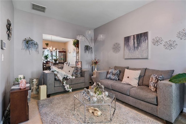 living room featuring an inviting chandelier and visible vents