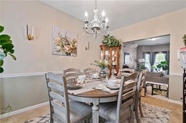 dining area with an inviting chandelier