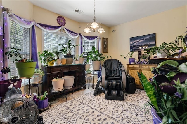 living area featuring an inviting chandelier and visible vents