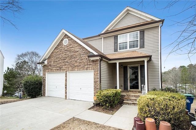 traditional-style house with stone siding, an attached garage, and concrete driveway