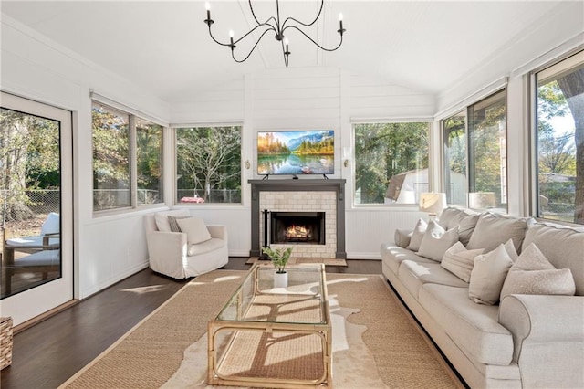 sunroom / solarium with an inviting chandelier and lofted ceiling