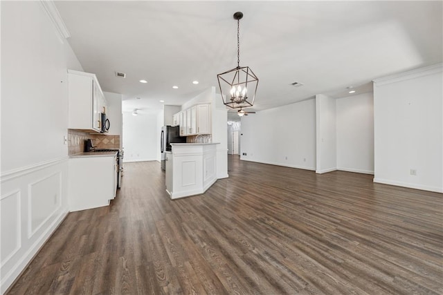 507 Bonneset Ct, Canton, GA 30114 - unfurnished living room featuring a chandelier, dark wood-style floors, recessed lighting, and crown molding