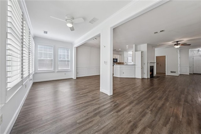 507 Bonneset Ct, Canton, GA 30114 - unfurnished living room featuring a ceiling fan, dark wood-style flooring, ornamental molding, a decorative wall, and a wainscoted wall