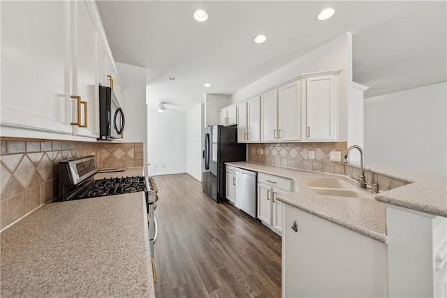 507 Bonneset Ct, Canton, GA 30114 - kitchen with stainless steel appliances, white cabinets, a peninsula, light stone counters, and dark wood-type flooring