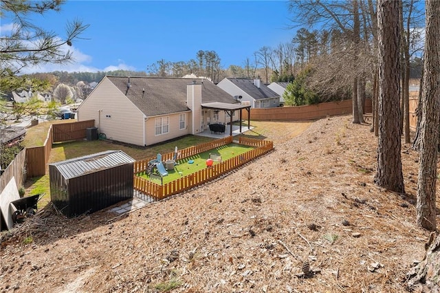 back of property with a yard and a fenced backyard