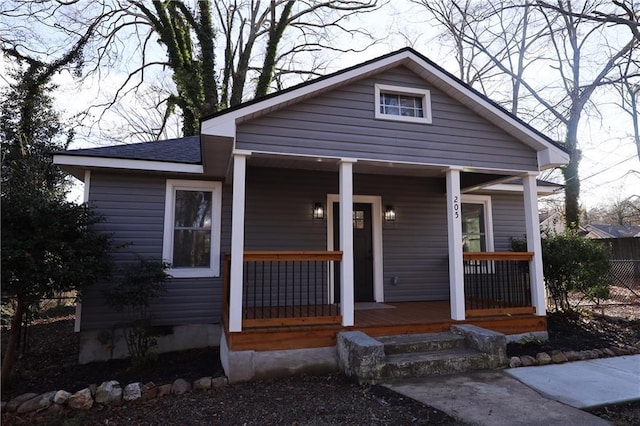 bungalow-style home featuring a porch and a shingled roof